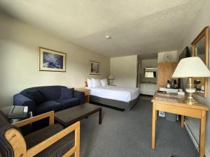 a hotel room with a bed and a couch at Chalet Inn in Kitimat