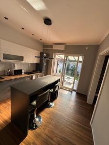a kitchen with a black table in a room at Apartman Golden in Senta