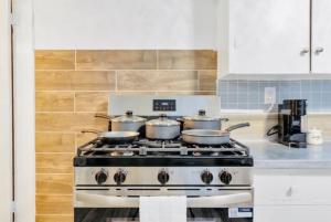 a kitchen with a stove with pots on it at Cozy Corner Buffalo Getaway in Buffalo