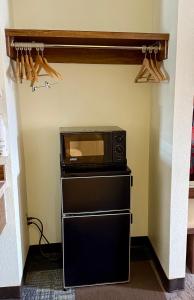a microwave sitting on top of a stove in a kitchen at Thunderbird Motel in Elko