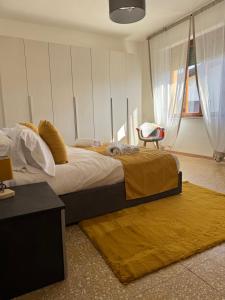 a bedroom with a large bed with a yellow blanket at Villa Elettra in Pisa