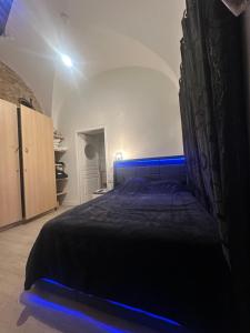 a bedroom with a large bed with blue lighting at Magnifique appartement neuf Bellecour in Lyon