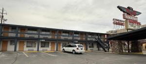 a white van parked in a parking lot in front of a hotel at Thunderbird Motel in Elko