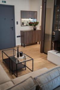a living room with a coffee table and a couch at The Fourth - Where Four Becomes Home in Larisa