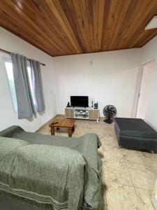 a living room with a bed and a tv at La Faustina in Chajarí