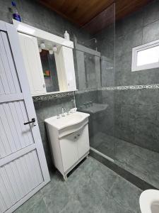 a bathroom with a sink and a toilet and a shower at La Faustina in Chajarí +13 photos