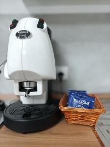 a white sewing machine sitting next to a basket at La Capaciota in Capaci
