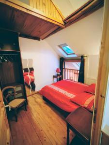 a bedroom with a red bed and a window at Spa et Sauna Le Roosevelt in Château-Thierry
