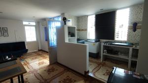 a kitchen with a white refrigerator in a room at Hostal Ángel Victoria in Yopal