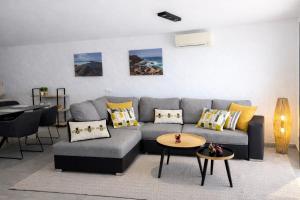 a living room with a couch and a table at Villa Sotavento Modern new apartment in Park Natural Adults Only in Playa Jandia