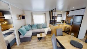 a large living room with a couch and a table at Vacances la Palmyre in Les Mathes