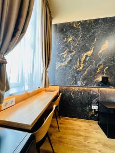 a dining room with a wooden table and a wall at Boutique Hotel & Event Center in Budapest +76 photos