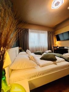 a bedroom with a large bed with pillows on it at Boutique Hotel & Event Center in Budapest