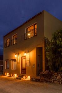 a house with lights on the side of it at night at Tala Huasi in Tilcara