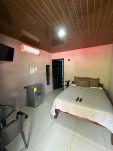 a bedroom with a bed and a tv in it at Cabinas Hukats Secret Jungle in Puerto Viejo