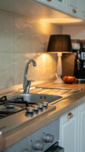 a kitchen with a stove top with a sink at Cozy Mountain Retreat in Transylvania Quiet Escape near Bran - Rai din Transilvania in Moieciu de Jos