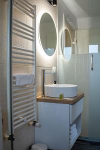 a bathroom with a sink and a mirror at Cozy Mountain Retreat in Transylvania Quiet Escape near Bran - Rai din Transilvania in Moieciu de Jos