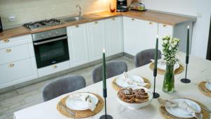 a kitchen with a table with food on it at Cozy Mountain Retreat in Transylvania Quiet Escape near Bran - Rai din Transilvania in Moieciu de Jos +44 photos