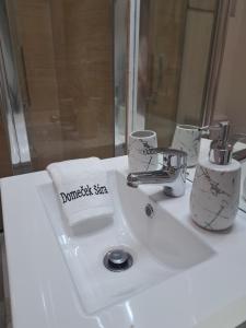 a bathroom sink with a towel and a faucet at Domeček Sára in Mohelnice