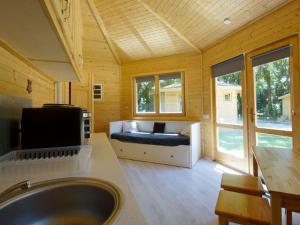 a large bathroom with a tub and a tv in it at Charmante Cabane 5 Pers, Chauffée - API-1-52-1704 in Champvert