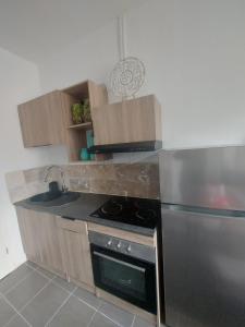 a kitchen with a stove and a sink at Lumière Luxembourg in Russange