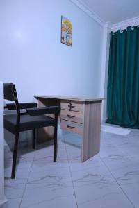 a desk and a chair in a room at Lola Homes Thika in Thika