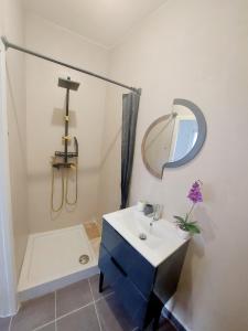 a bathroom with a sink and a mirror and a tub at Lumière Luxembourg in Russange