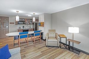 a kitchen and living room with a table and chairs at Candlewood Suites - Topeka West by IHG in Topeka