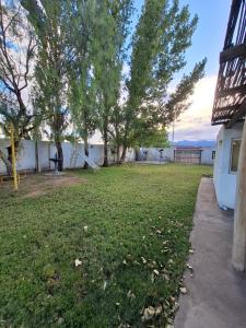 a yard with trees and a white building at San Antonio Casa Quinta in Banda Florida
