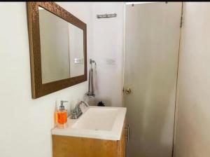 a bathroom with a sink and a mirror at Casa Natalia Welcome in La Paz +9 photos