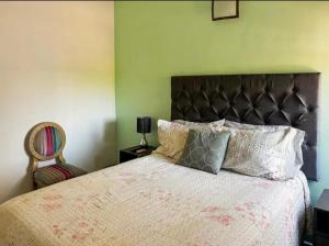 a bedroom with a large bed and a chair at Casa Natalia Welcome in La Paz