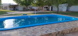a swimming pool in a yard with a blue coping at San Antonio Casa Quinta in Banda Florida
