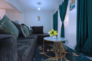 a living room with a couch and a table at Lola Homes Thika in Thika +1 photo