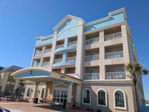 a large apartment building with a blue at Holiday Inn Express & Suites Galveston West-Seawall by IHG in Galveston