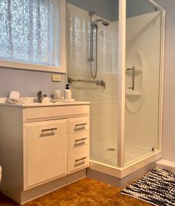 a bathroom with a shower and a sink at Howrah Apartment in Howrah