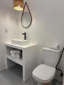 a bathroom with a sink and a toilet and a mirror at Amagali Beach Club in Galinhos +34 photos
