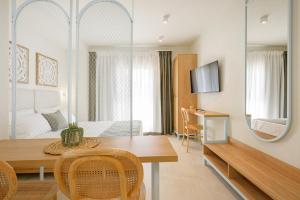 a room with a dining table and a bedroom at Leon Apartments in Ierissos