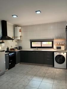 a kitchen with a washing machine and a washer at Confort urbano - Departamento de 1 dormitorio con cochera in Venado Tuerto