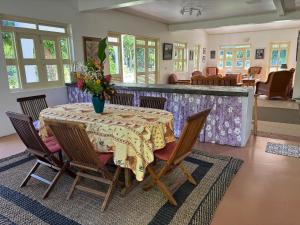 a dining room with a table with a vase of flowers on it at Waterlily House in HUH