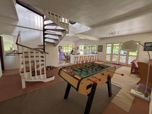 a living room with a pool table and a staircase at Waterlily House in HUH
