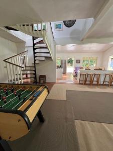 a living room with a pool table and stairs at Waterlily House in HUH