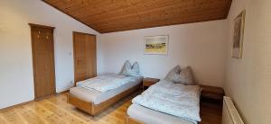 a room with two beds with pillows in it at Lauermann's Gästehaus in Felixdorf