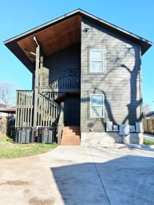 a house with a staircase on the side of it at Xscapecatio Oasis II in Tulsa