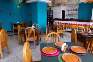 a dining room with tables and chairs and blue walls at Hotel Escala Siglo XXI in Mexico City +56 photos