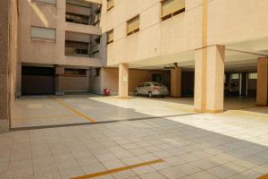 a parking lot with a car parked in front of a building at Hotel Escala Siglo XXI in Mexico City