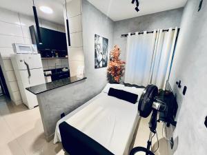 a room with a bed with a camera in it at Residencial Mª Do Bonfim - 5km Aeroporto JK in Brasília