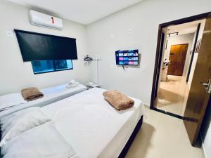 a hospital room with a bed and a tv at Residencial Mª Do Bonfim - 5km Aeroporto JK in Brasília