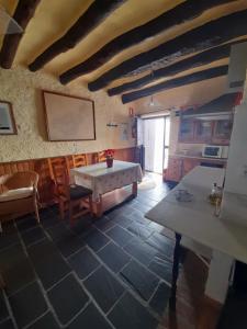 a room with a table and chairs in a building at Casa-Huerto La Juana in Trevélez