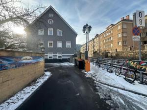 a snowy street with bikes parked next to a building at Urban Spacious Bright Apartment with DanubeView in Linz