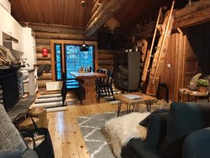 a living room with a couch and a table at Holiday Hopsukka in Luosto
